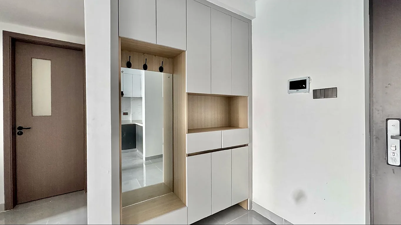 Built-in entryway cabinets with a tall mirror, coat hooks and an open shelf at Capital Garden, Hurlingham.