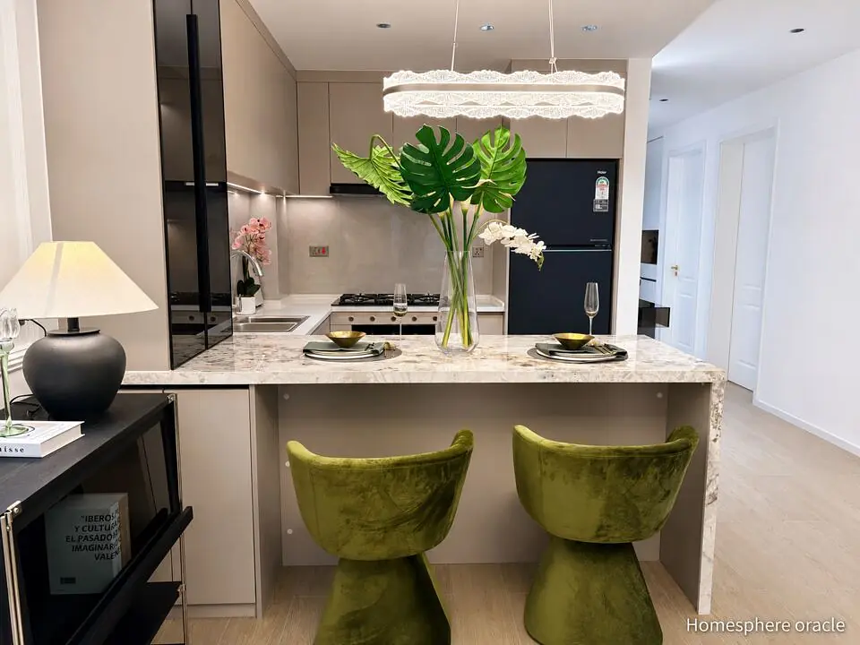 Kitchen with a breakfast bar, two green chairs and pendant lighting at Capital Heights, Westlands.
