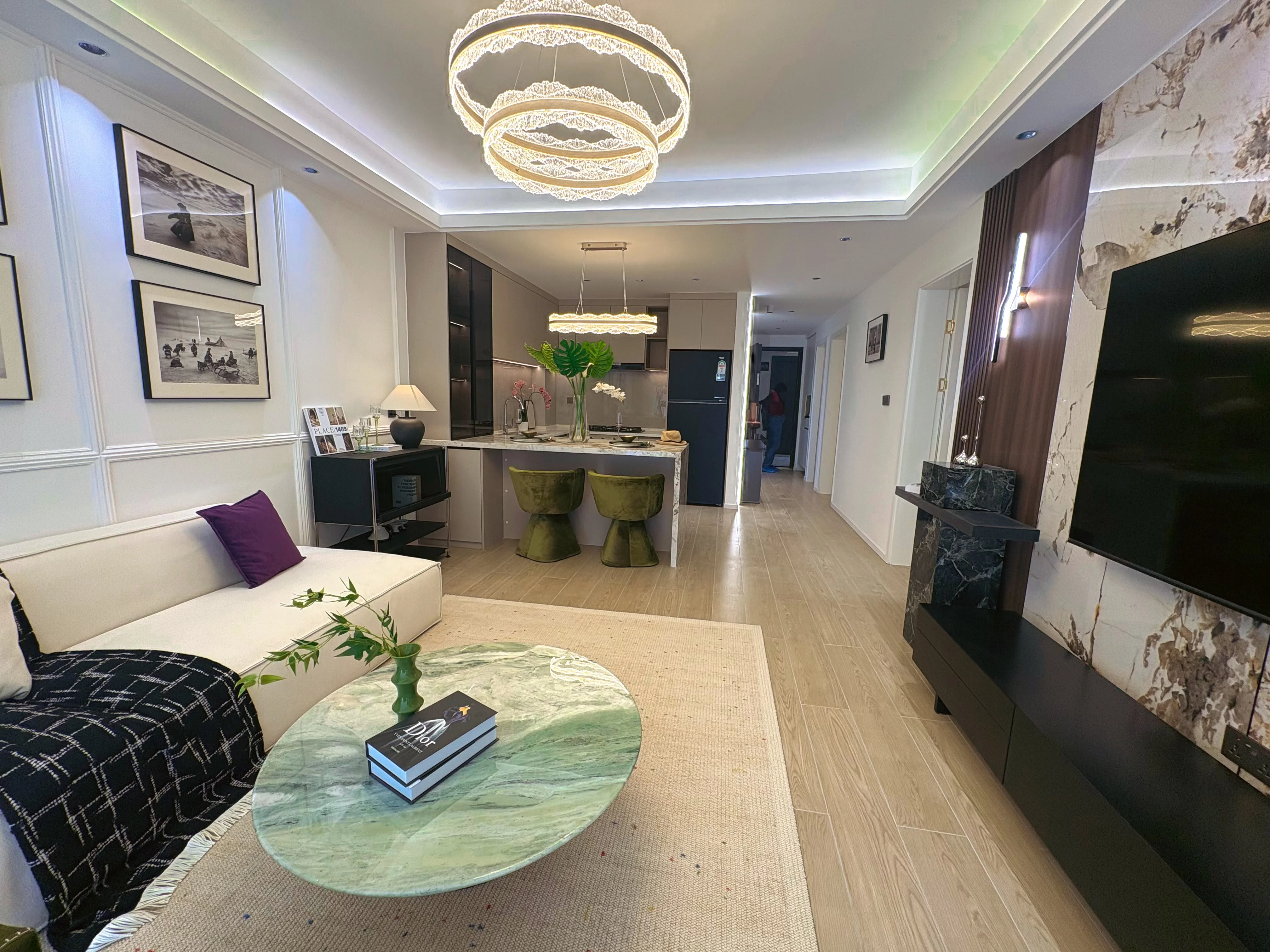 Open-plan living room and kitchen at Capital Heights, Westlands, with a cream sofa and green stools.