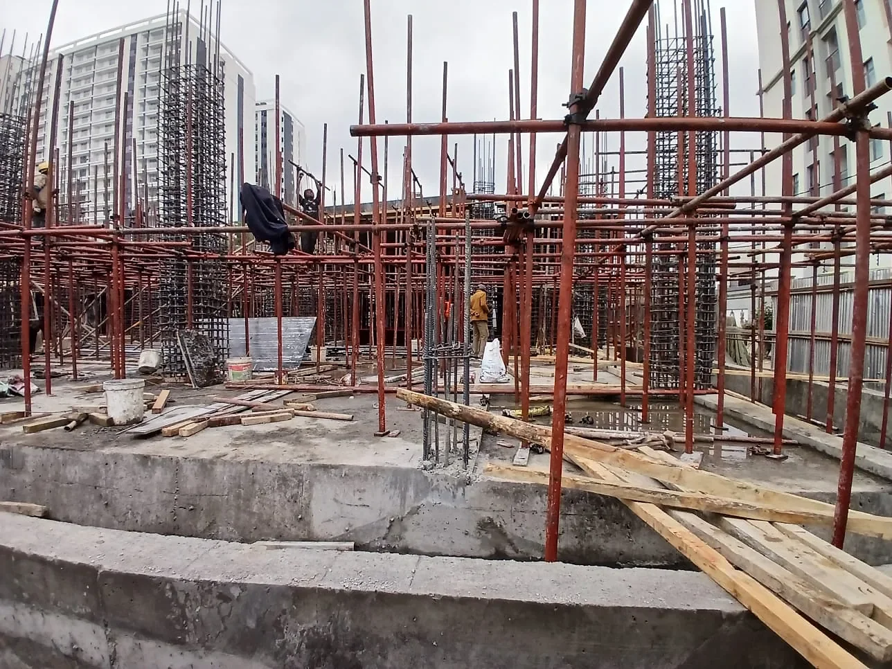 Capital Vista construction site in Kilimani, with scaffolding, exposed reinforcement bars and timber planks.