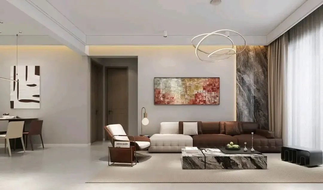 Living and dining area at Citrine Heights, Westlands, with a sectional sofa, coffee table and curtained windows.