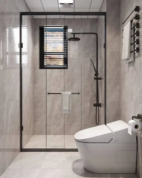 Bathroom at East Vista Residence, Parklands, with a glass-enclosed shower, black fixtures and a white toilet.