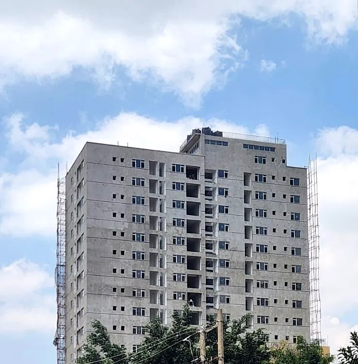 Lido Garden Apartments in Kilimani under construction, with an unfinished grey exterior and scaffolding along the sides.