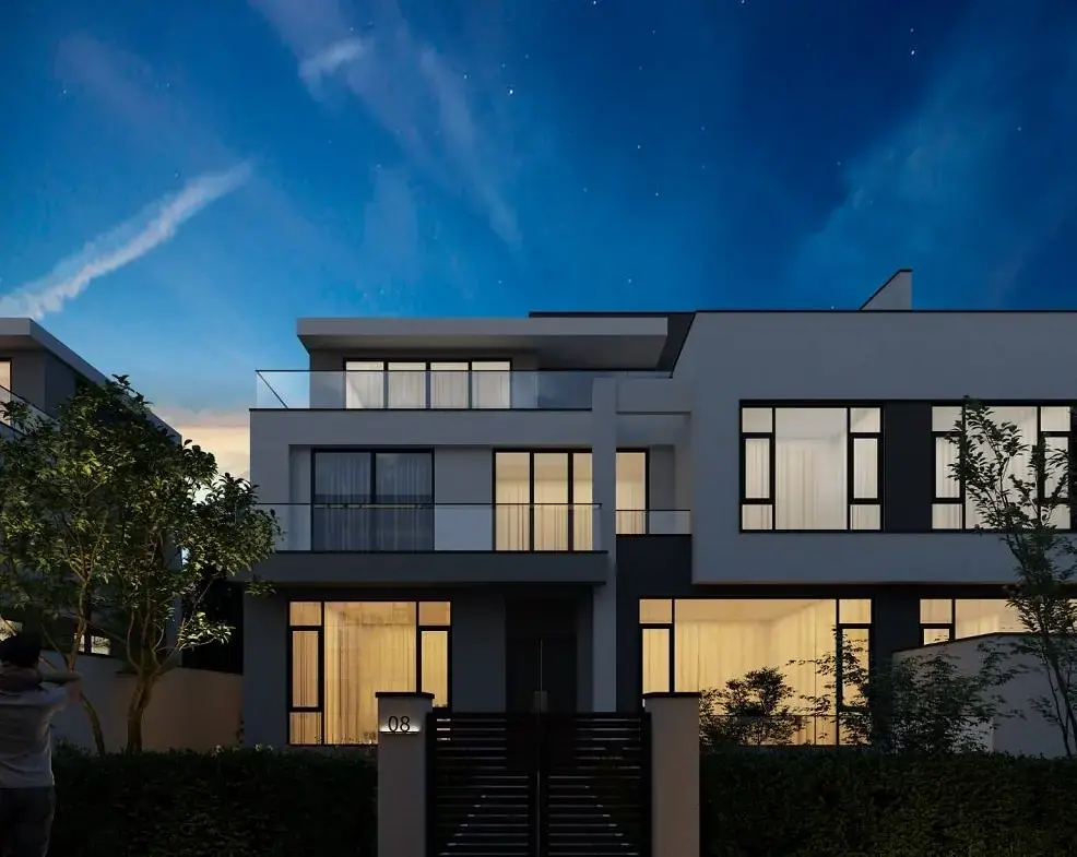 Onlyou Njumbi Villas exterior rendering at dusk, with illuminated windows, glass balconies and a gated entrance.