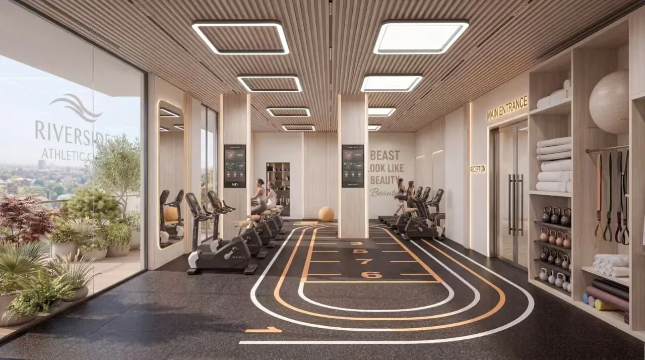 Gym rendering at Riverside Times Apartments with exercise bikes, kettlebell shelving and marked floor lanes.