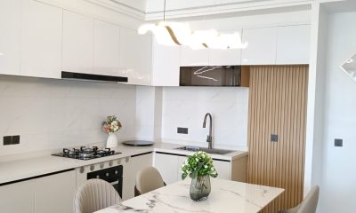 Kitchen and dining area with white cabinets and beige chairs at San Remo Heights, Westlands.