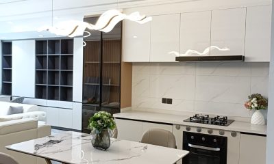 Kitchen and dining area at San Remo Heights, Westlands, with white cabinetry, built-in oven and pendant lighting.