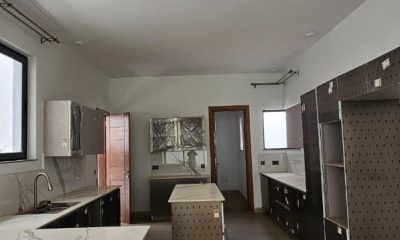 Kitchen at San Remo Heights, Westlands, with a central island, sink and unfinished cabinetry.