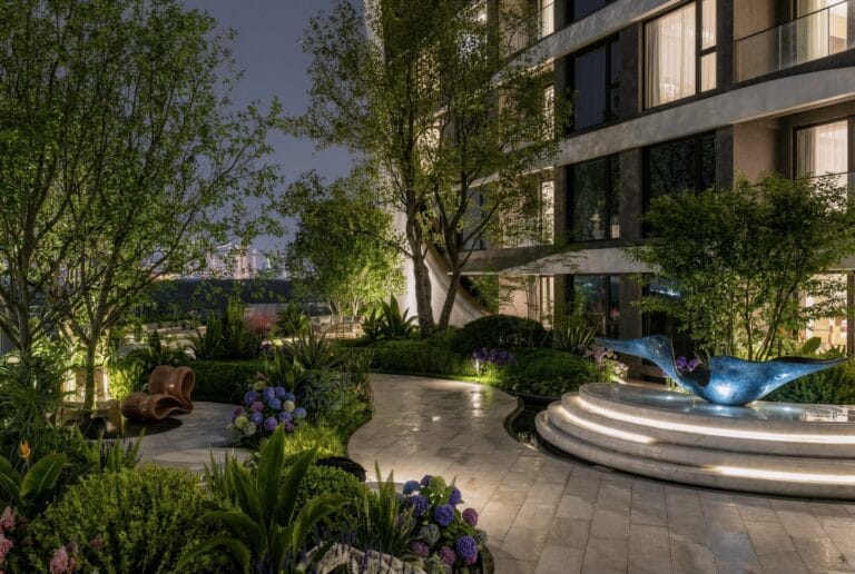 Landscaped courtyard rendering at Santorini Residences, Westlands, with curved paths, trees and a blue sculpture.