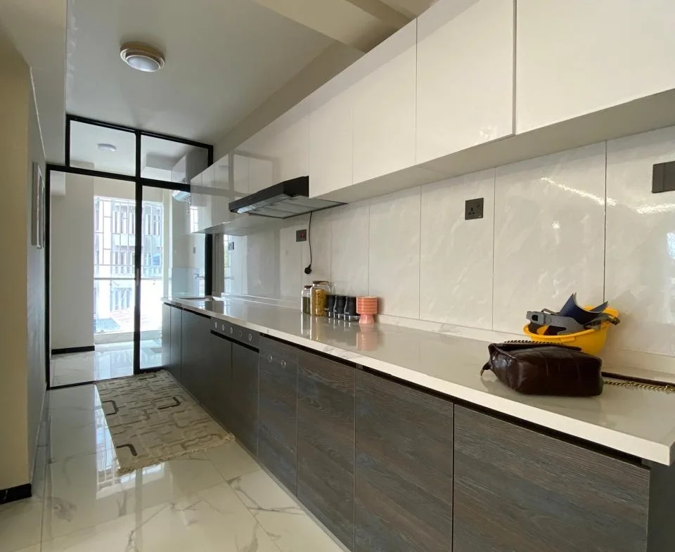 Super Westbury kitchen in Westlands with white upper cabinets, dark lower cabinets and a built-in oven.