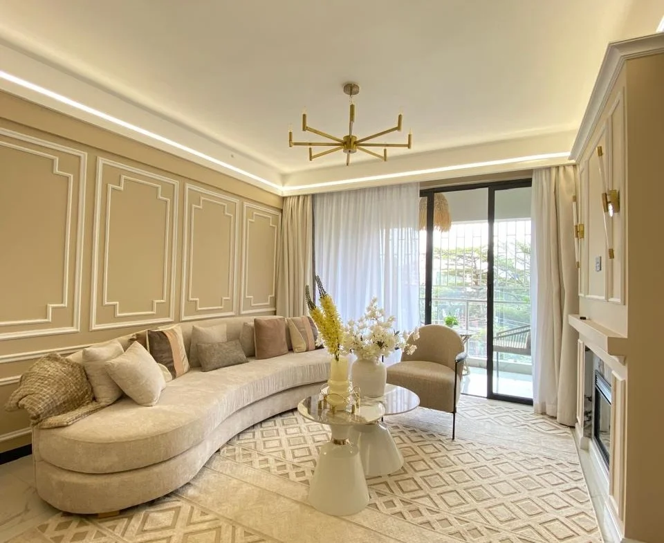 Living room at Super Westbury, Westlands, with a curved cream sofa and sliding glass balcony doors.
