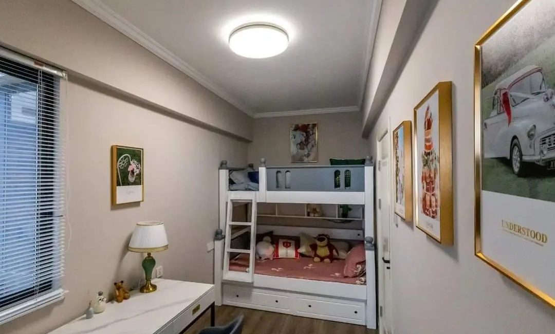 Bedroom at Versailles Garden, Kileleshwa, with a bunk bed, desk, table lamp and framed wall art.
